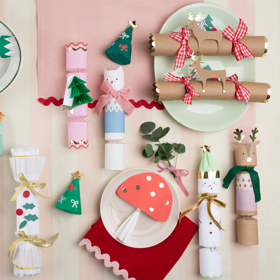 Our family crackers feature jolly snowmen with scarves and hat embellishments, and contain a joke, party hat and a fun eraser.