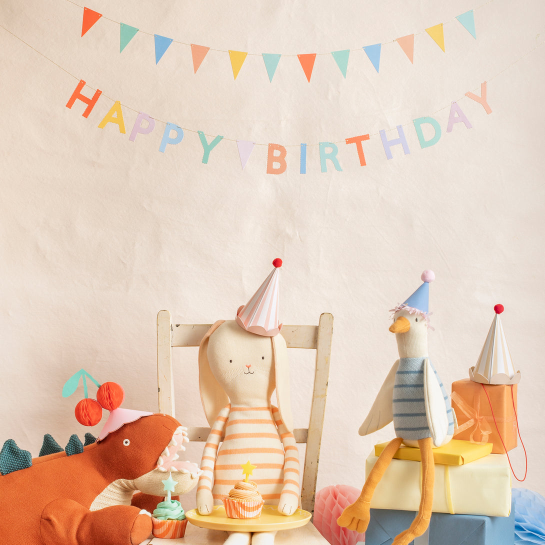 Our birthday garland set includes one that spells out Happy Birthday and another with flag pennants, in bright colours.