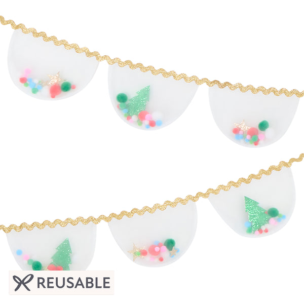 Our Christmas garland features white organza pennants filled with pompoms and glitter fabric stars and Christmas trees, with a ric rac trim. Image1