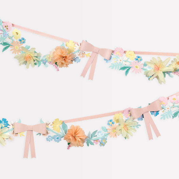 Our paper garland, featuring flowers and bows, is the perfect baby shower garland or Easter garland.