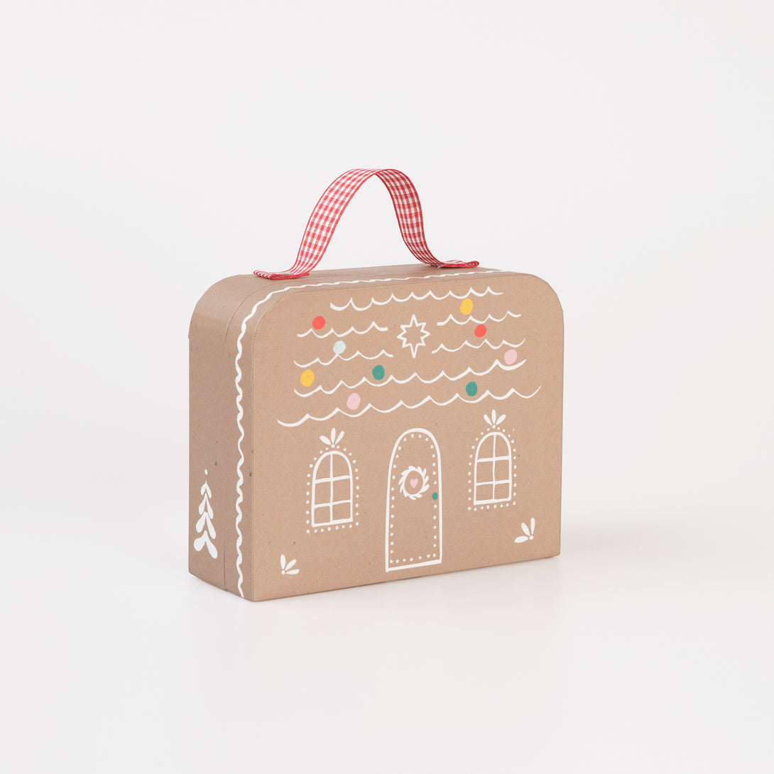 Our Christmas doll set includes a mini fabric reindeer doll in a laminated mini suitcase designed to look like a gingerbread house.