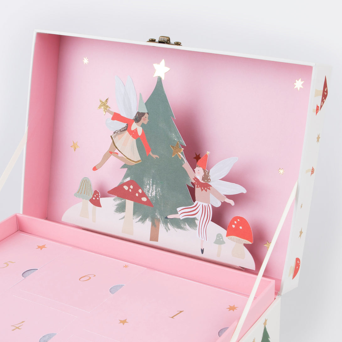 Our wooden advent calendar contains a woodland scene complete with paper fairies, presented in a suitcase, a fun interactive gift