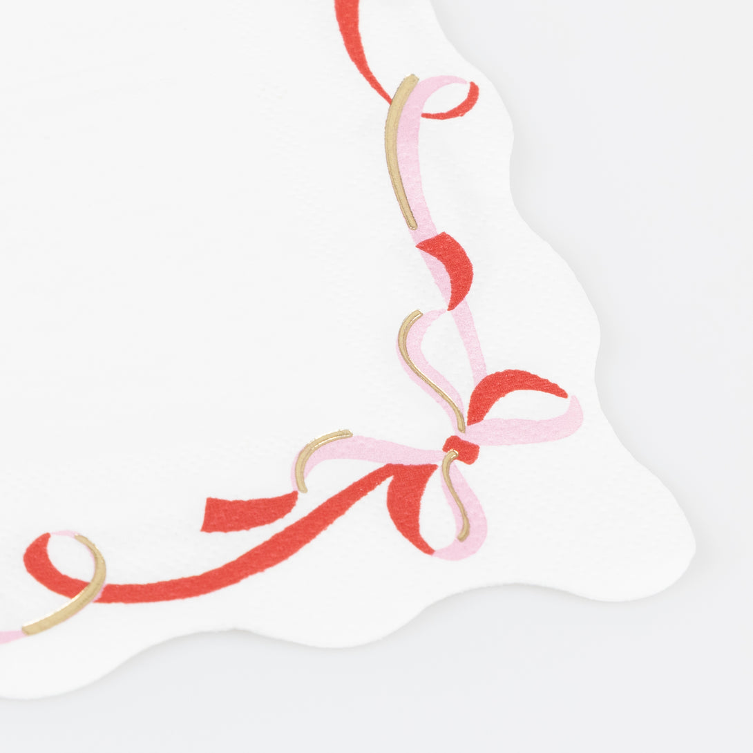Our small paper napkins feature a modern ribbon bow design, in pink, red and gold, perfect for your Christmas dinner or a cocktail party. Image2