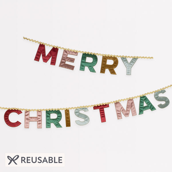 Our Merry Christmas garland is made in velvet with a mix of traditional and modern colours and metallic gold ric rac. Image1