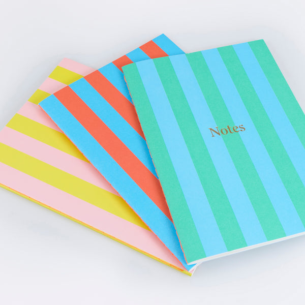 Our lined notebooks come in a set of 3, beautifully designed with vibrant striped covers and a neon coral stitched spine. Image3