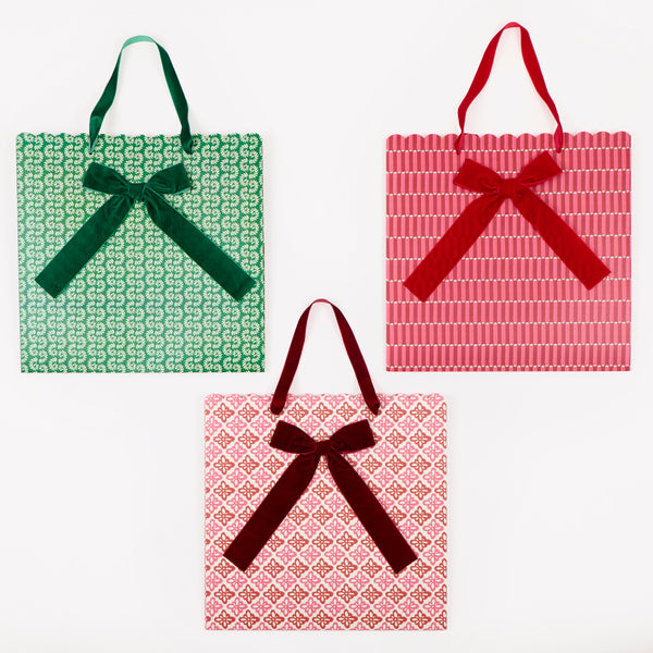 Our large Christmas gift bags, made from premium paper, feature Molly Mahon block print designs with velvet bows and velvet handles. Image3