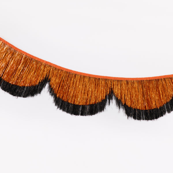 Our Halloween garland features 2 foil tinsel fringe layers in classic orange and black, with scalloped shapes, that catch the light beautifully. Image3