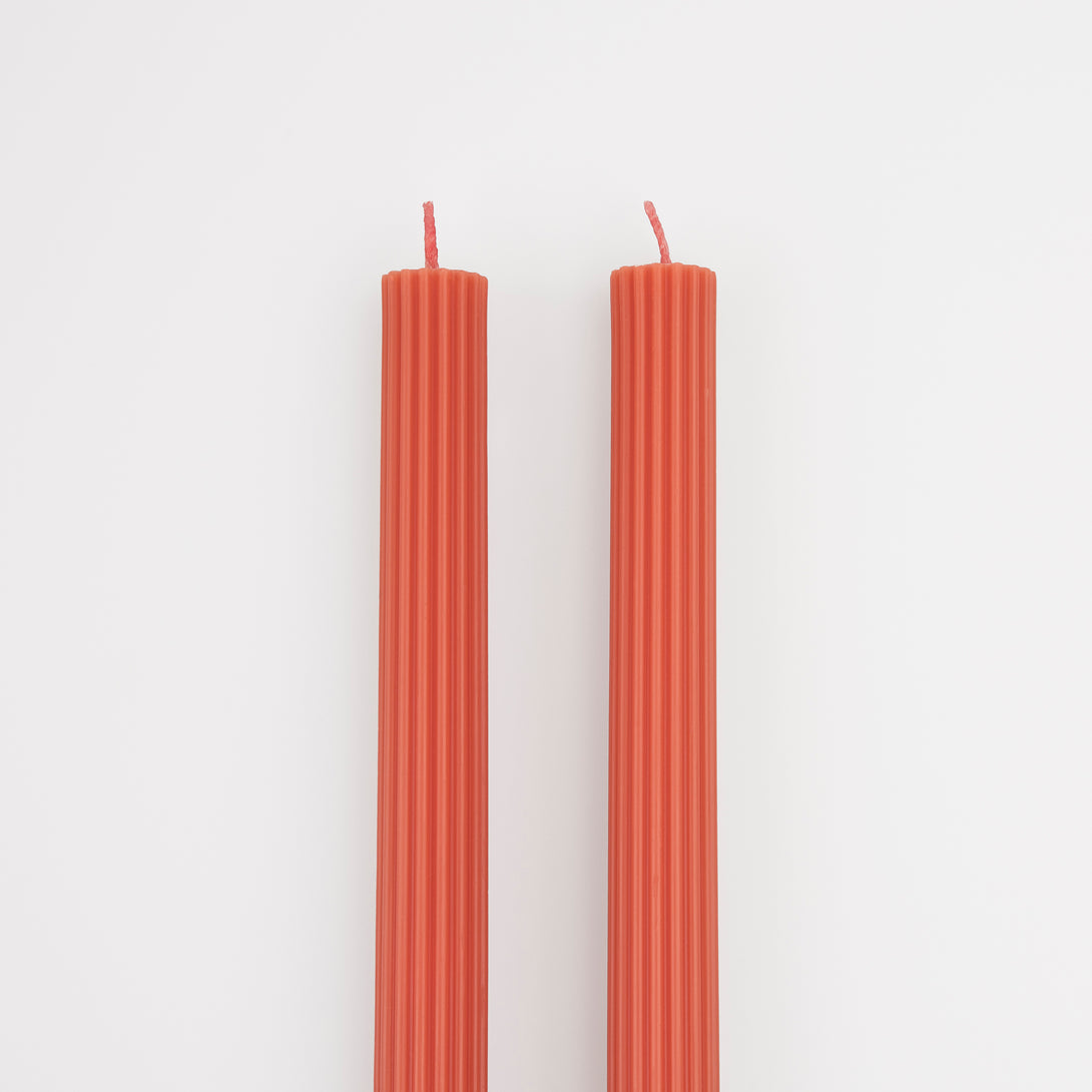 Our tall candles, in coral, are wonderful as a hostess gift or table decoration.