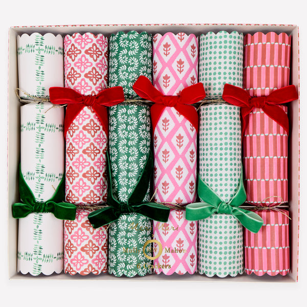 Our luxury Christmas crackers feature Molly Mahon block print designs in seasonal colours and velvet bows, with a hat, joke and special gift inside. Image1