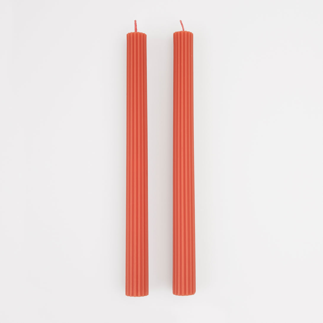 Our tall candles, in coral, are wonderful as a hostess gift or table decoration.