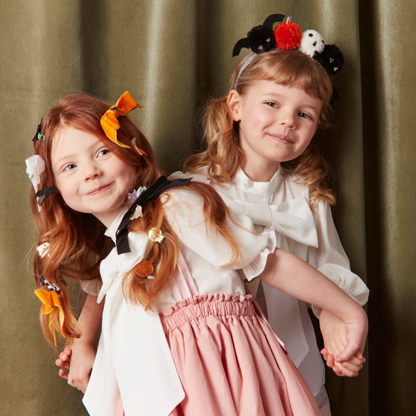 Add our Halloween headband, with fun pom pom details, to your Halloween accessories for a thrilling look. Image2