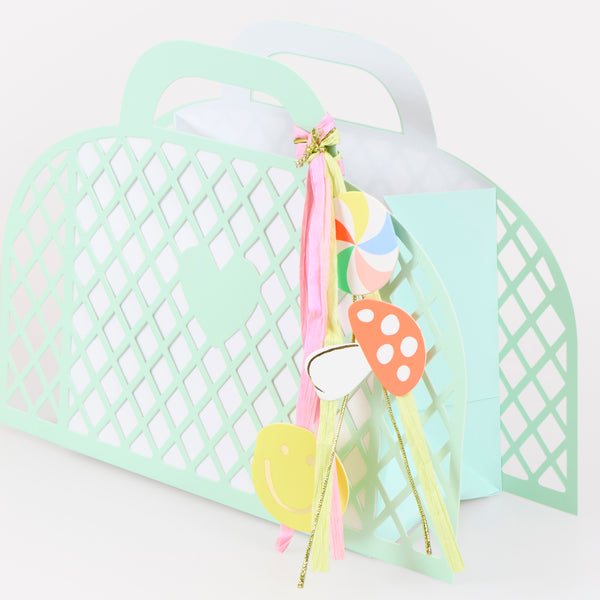 Our party favour bags are designed to look like little baskets, in pink, blue, mint and yellow, complete with paper charms tied on with ribbons. Image5