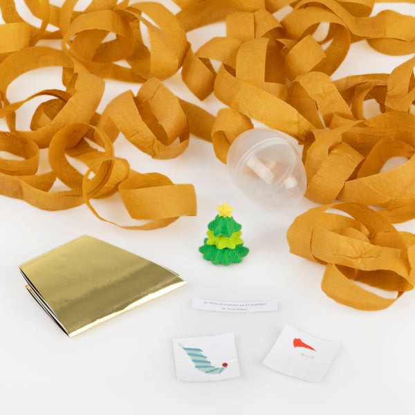 Our surprise balls, in the shape of Santa, a snowman and a reindeer, contain a gold party hat, 2 stickers, a joke and a fun eraser. Image2