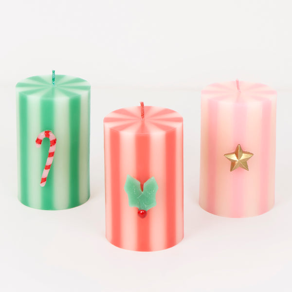 Our Christmas candles, in a stylish pillar shape, feature, green, red, white and pink stripes, with wax icons and elegant coloured wicks. A great gift. Image1