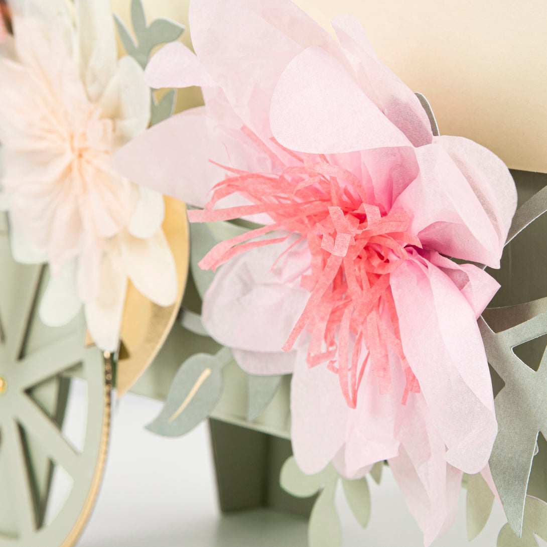 Beautiful pastel plates, cups, napkins, floral garland, and a centrepiece to display macarons. 