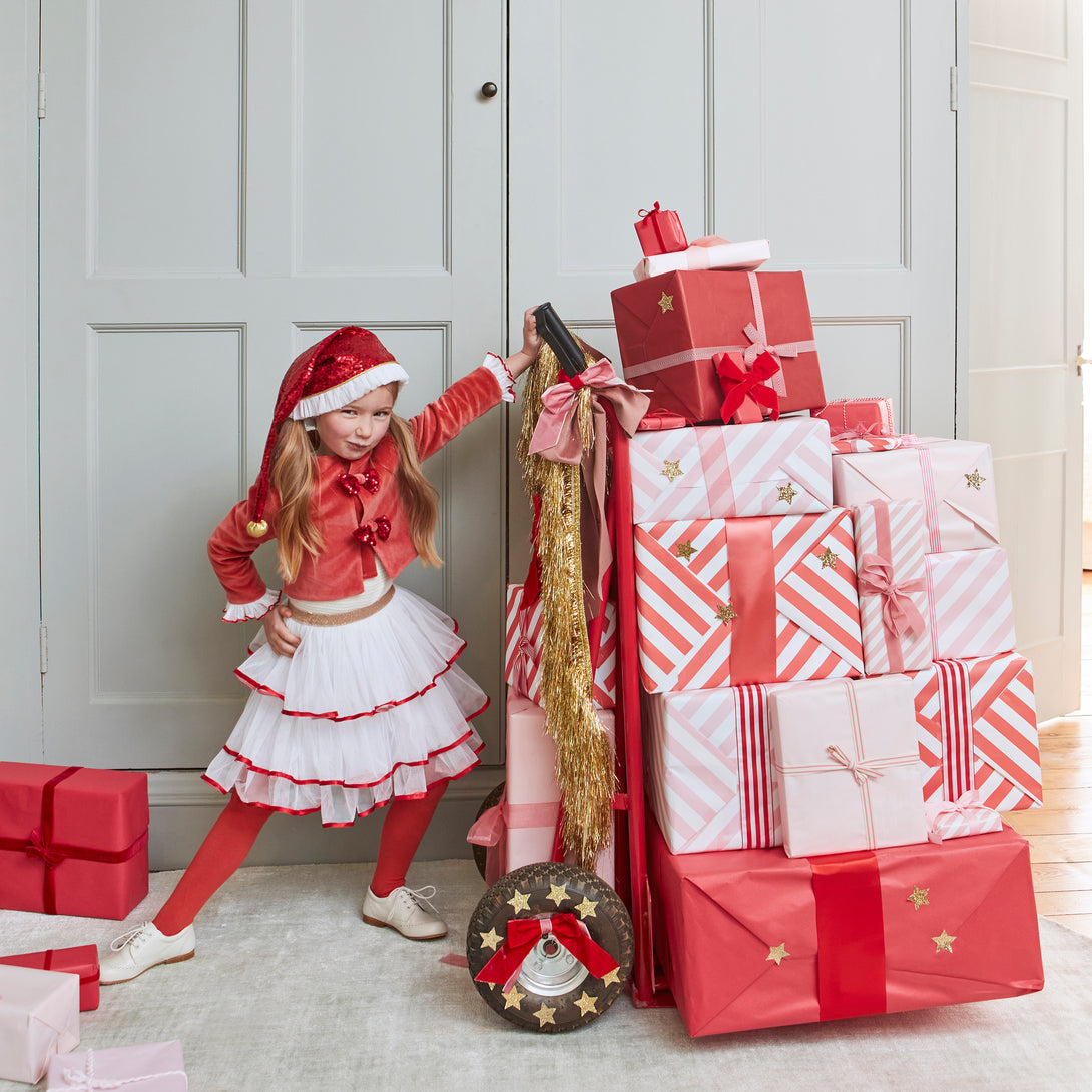 Make your kids look amazing this Christmas with a red and white Christmas costume of a velvet skirt, tulle jacket and red Santa hat.