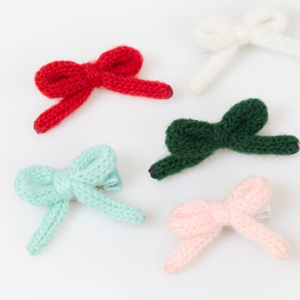 Our Christmas hair clips feature knitted bows and velvet ribbon details in red, pink, white, mint and green, for a wonderfully stylish look. Image3