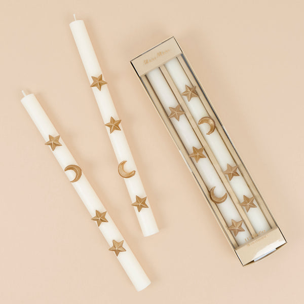 Our Halloween candles, in ivory with ivory wicks, feature hand painted gold ink moons and stars for an elegant celestial effect. Image1