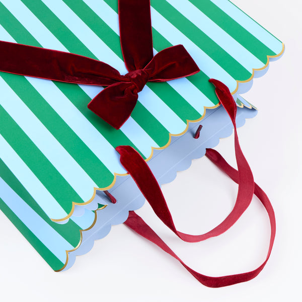 Our Christmas gift bags, made from premium paper, feature stripes of red, burgundy, green, pink and blue with velvet bows and velvet handles. Image3