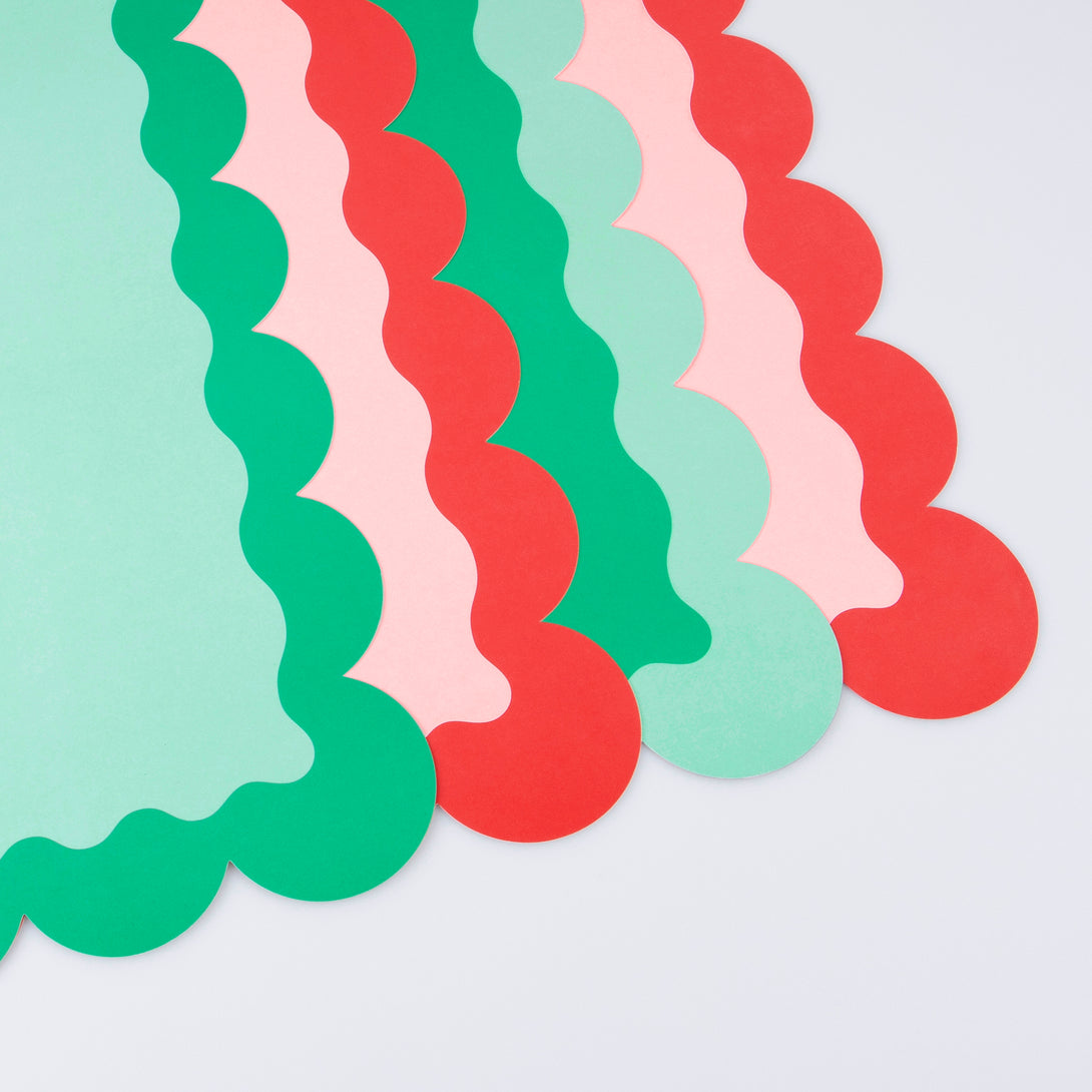 Our paper placemats are crafted in Christmas colours of red and green, with a modern pop of pink, and stylish scalloped edges.