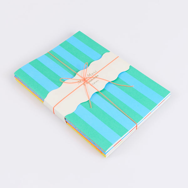 Our lined notebooks come in a set of 3, beautifully designed with vibrant striped covers and a neon coral stitched spine. Image1