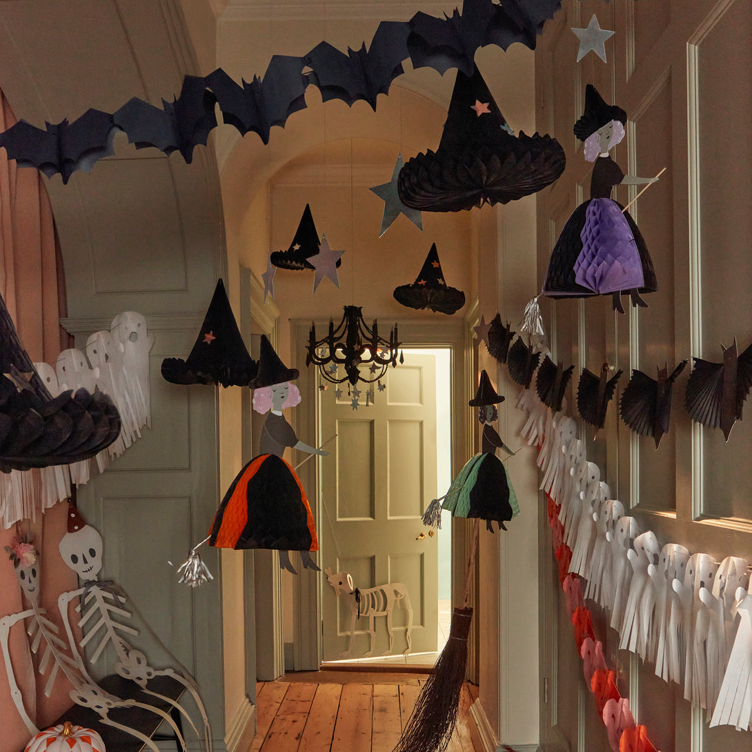 Our Halloween hanging decorations feature happy witches with honeycomb details, and shiny silver stars and a moon.