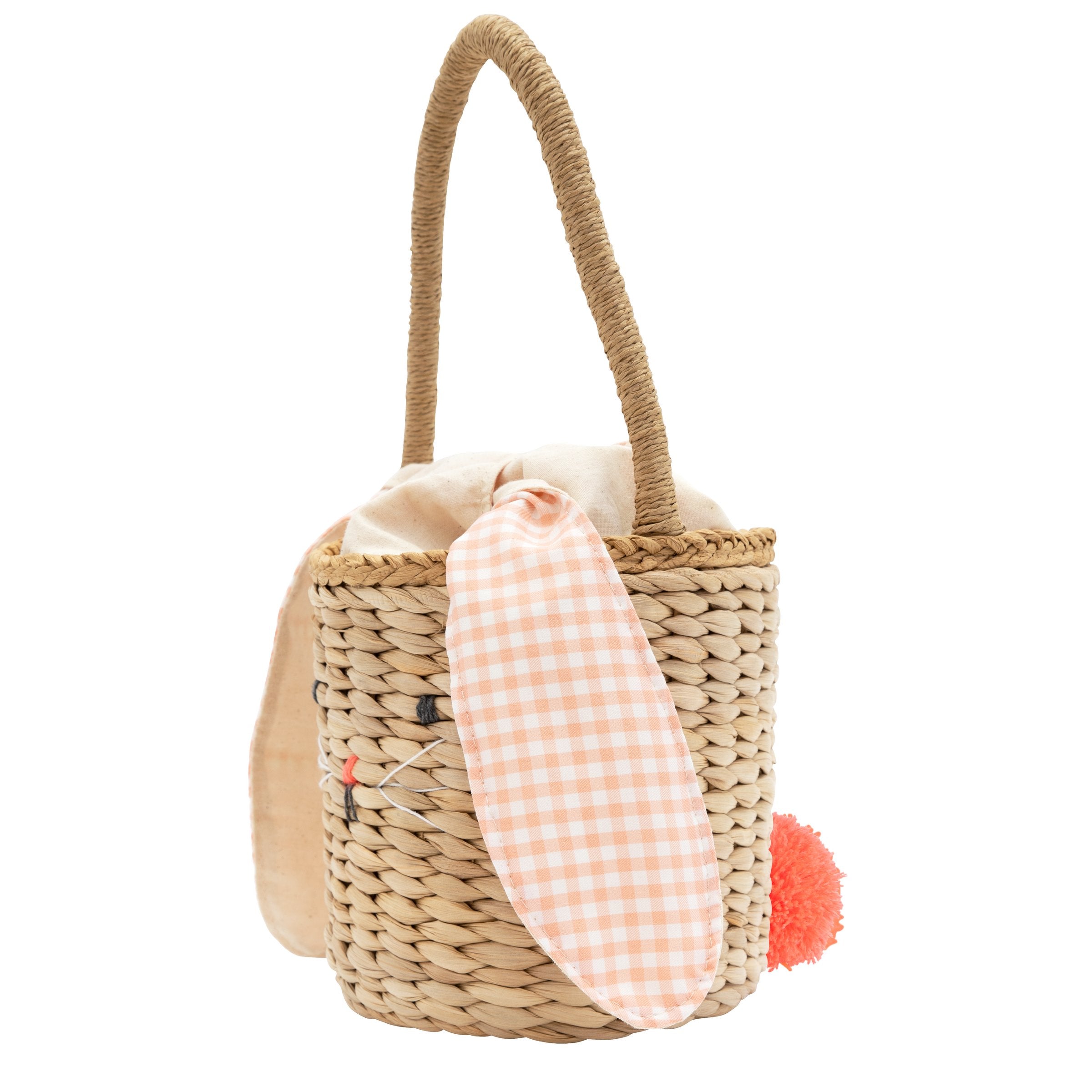 This basket is crafted from woven straw, with floppy ears, a sweet bunny face and a dellightful pompom tail.
