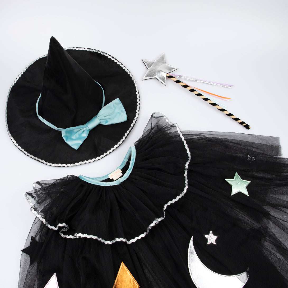 Our luxury witch costume set includes a tulle cape, an witch hat with a velvet bow and a colourful ribbon wand with a silver sequin star.