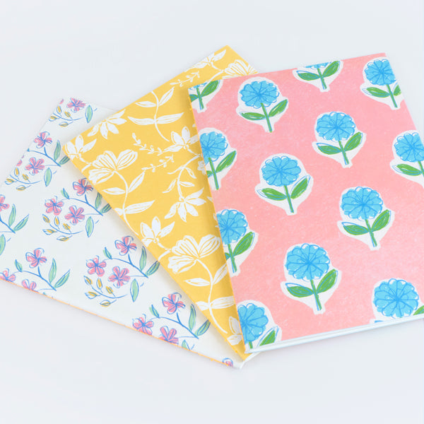 Our lined notebooks come in a set of three, all with pretty floral covers, and tied together with a paper band and neon coral cord, a lovely gift. Image2