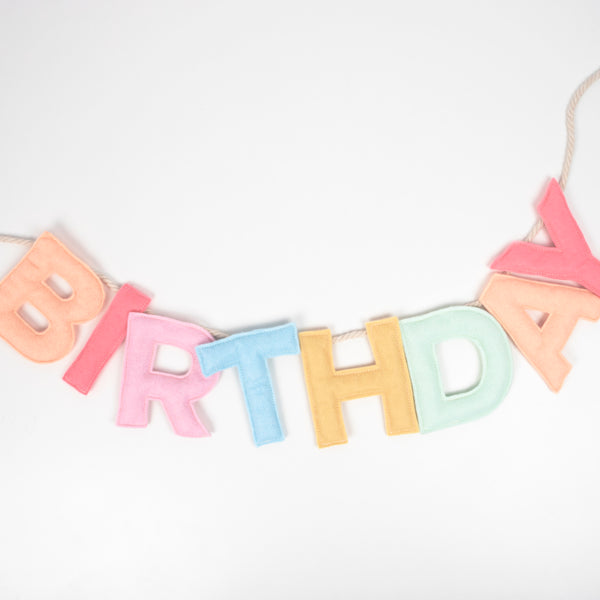 Add a rainbow of colour to your birthday party supplies with a colourful felt garland, paper tablecloth and bright birthday cake candles.  Image3