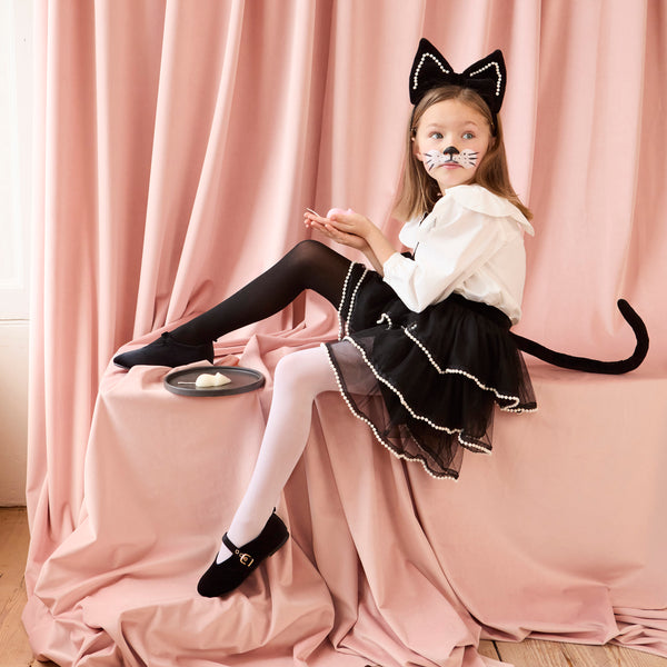 Look purr-fect in this Halloween costume, a black skirt with a detachable cat tail and a black velvet cat ear headband. Image1