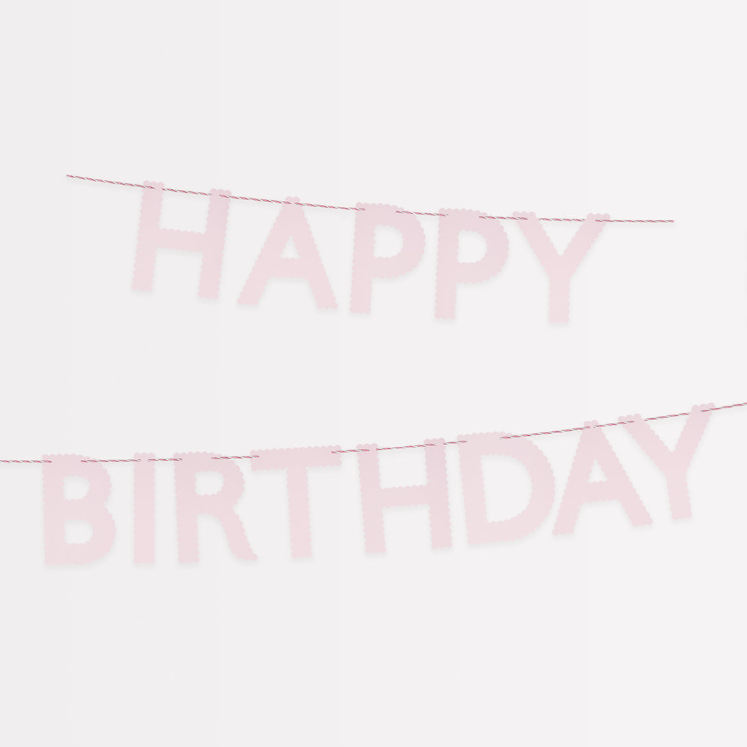 Our pink garland, made with scalloped pink paper, is a pretty decoration for a birthday party.