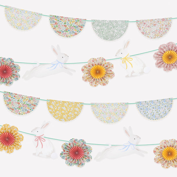 Our Easter decoration set includes 2 paper garlands with Liberty floral design flower pinwheels and scalloped shapes, and Easter bunnies. Image1
