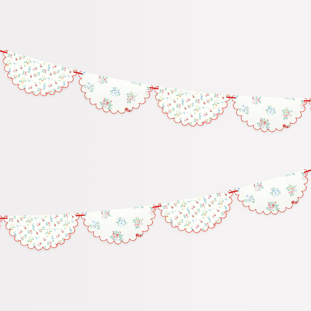 Our paper garland features pretty floral designs and a red ribbon, ideal as a baby shower garland, for bridal showers or garden parties.