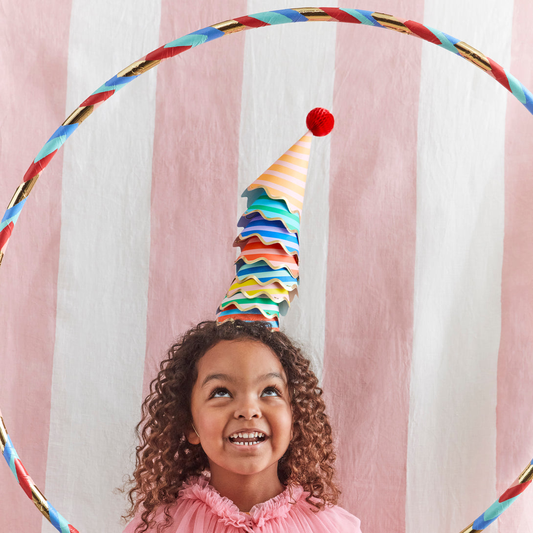 Our party accessories include hats with stripes and pompoms for a fun look.