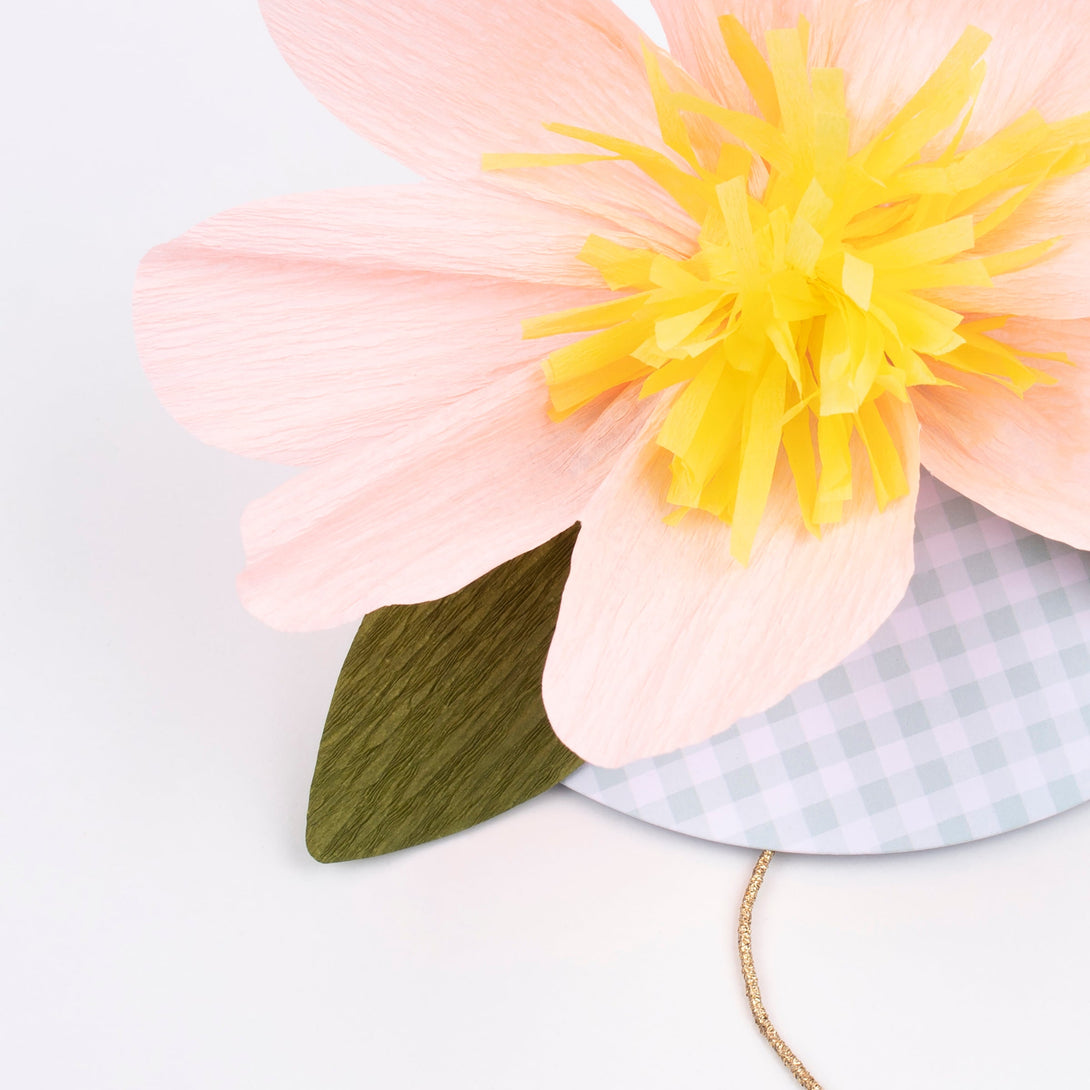 Our fabulous paper hats, with a large flower design and on trend green gingham details, are the perfect kids party hats.