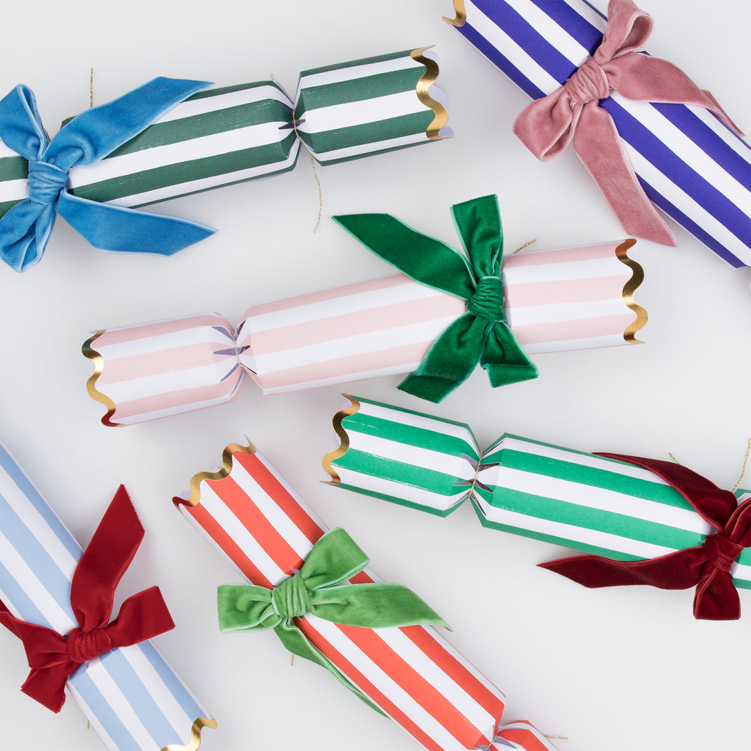 Our luxury crackers, with stripes and bows, contain fun erasers, paper party hats and more.