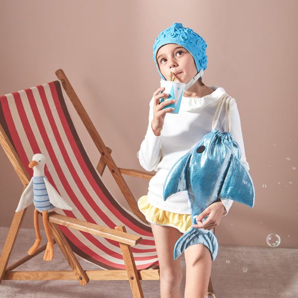 This shiny shark is  a backpack crafted from blue lamé fabric with a cotton lining and cord straps. Image2