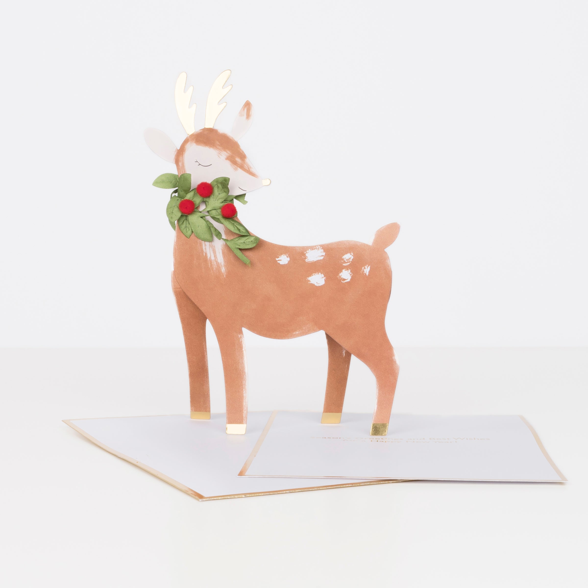 This gorgeous 3D Christmas card features a reindeer with gold foil, ribbon and pompom details.