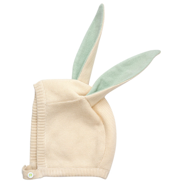 This delightful bunny baby bonnet is crafted from knitted organic cotton, with mint detail on the ears, and fastens with ivory coloured buttons. Image5