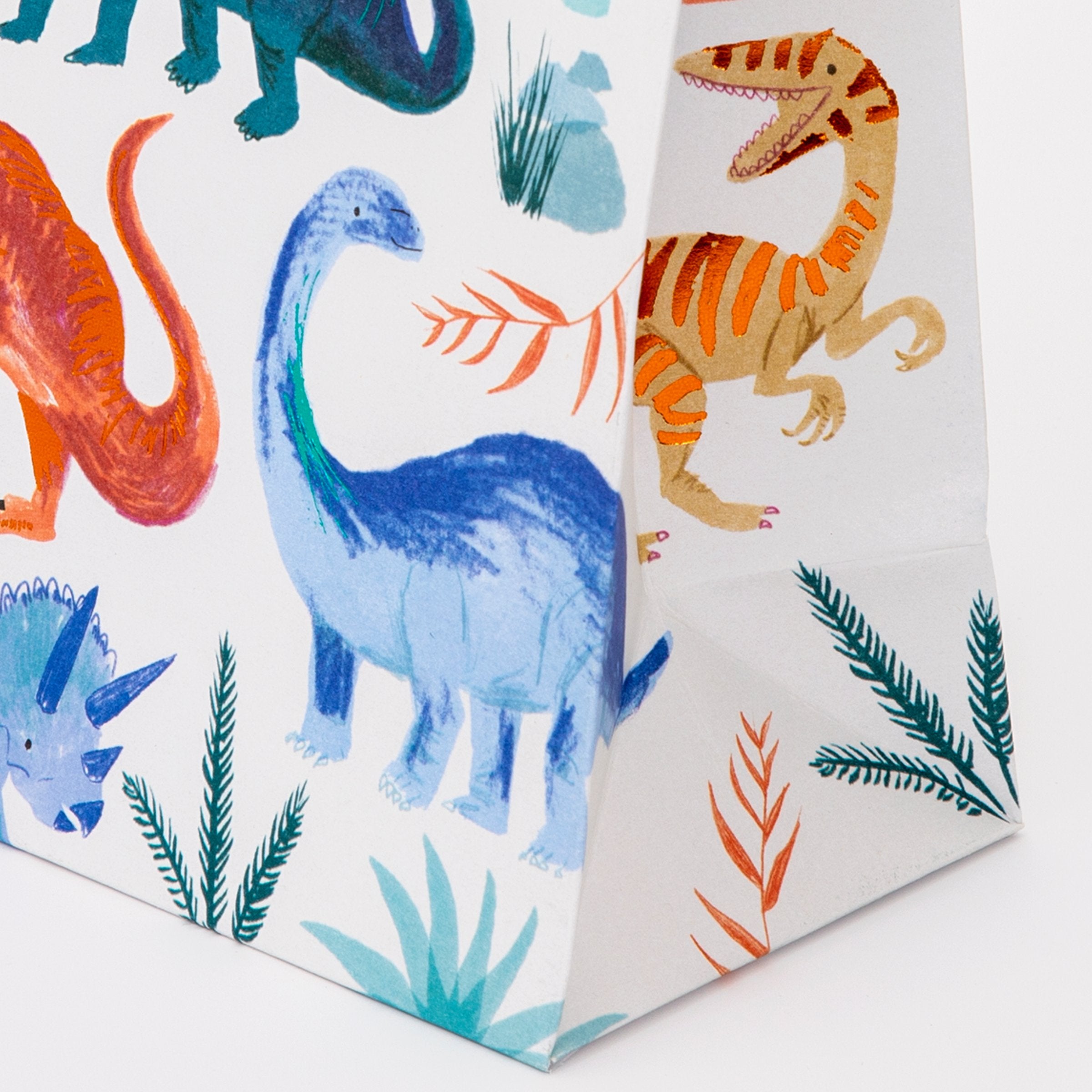 Our colourful dinosaur goodie bags, with a twisted paper handle, look amazing.