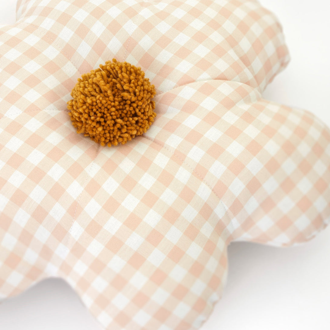 This decorative gingham print cushion is crafted in the shape of a daisy with a fun pompom centre.