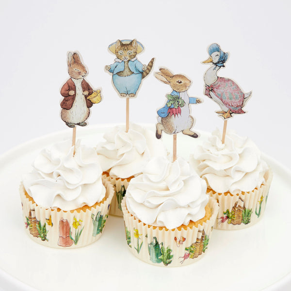 This delightful cupcake kit includes 24 Peter Rabbit characters' toppers with coordinating cupcake cases. Image2