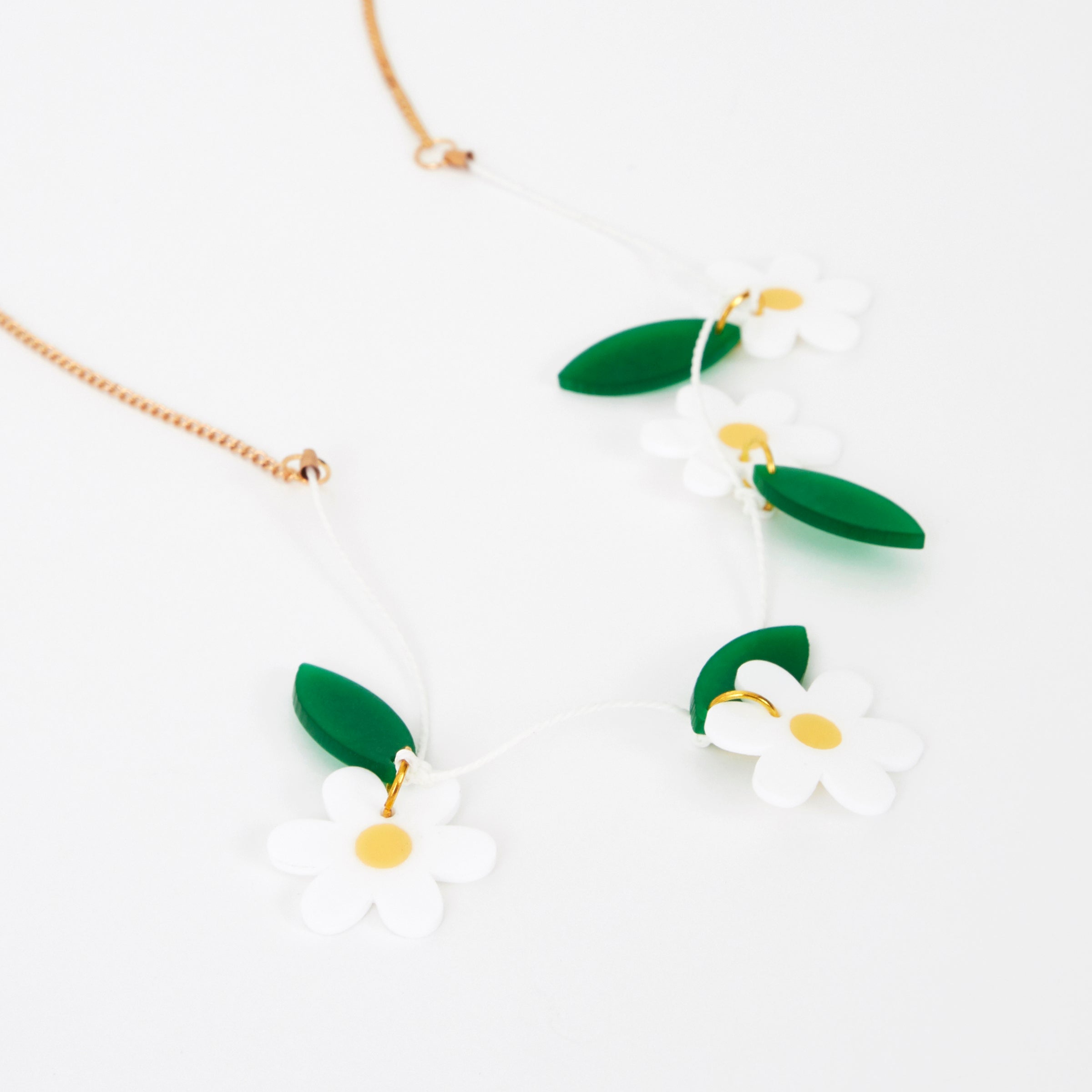 Our colourful daisy necklace is crafted from acrylic with a gold tone chain.