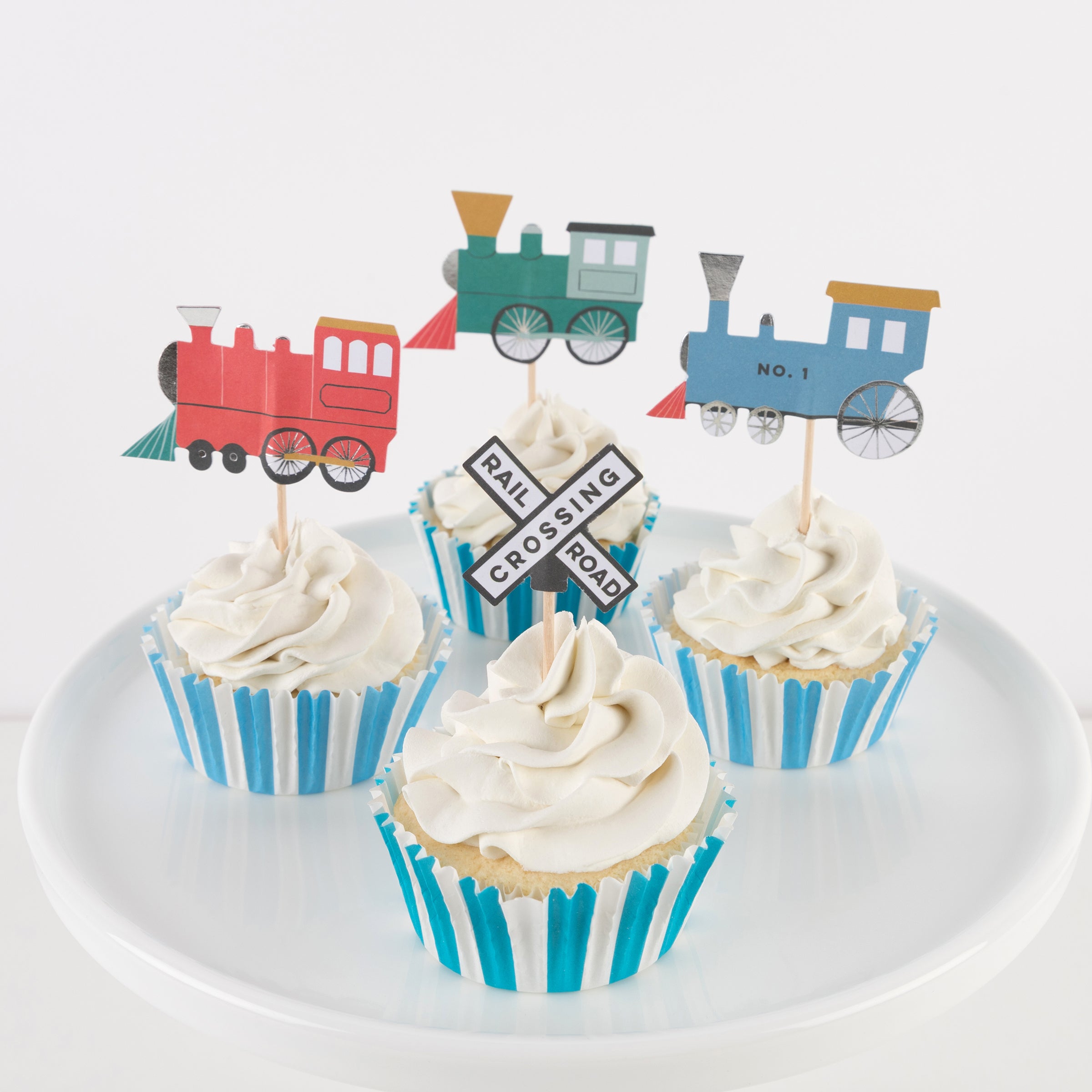 Our special cupcake kit feature train cake toppers and striped blue and teal cupcake cases.